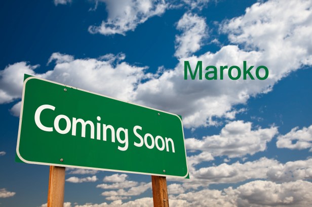 Coming Soon Green Road Sign with Copy Room Over The Dramatic Clouds and Sky.